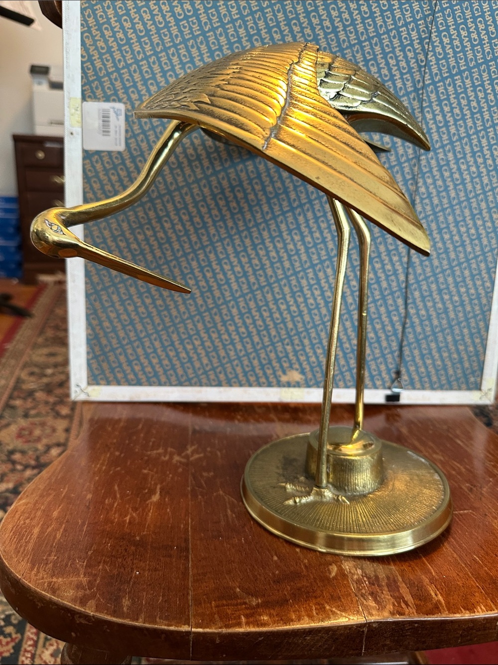 Vintage solid brass crane statue on a base